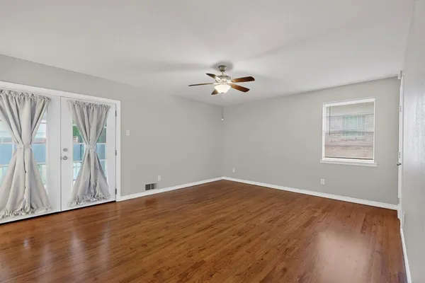 wooden floor in an empty room with a window