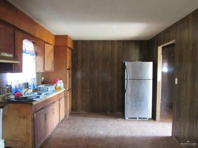 a kitchen that has a lot of cabinets and wooden floor