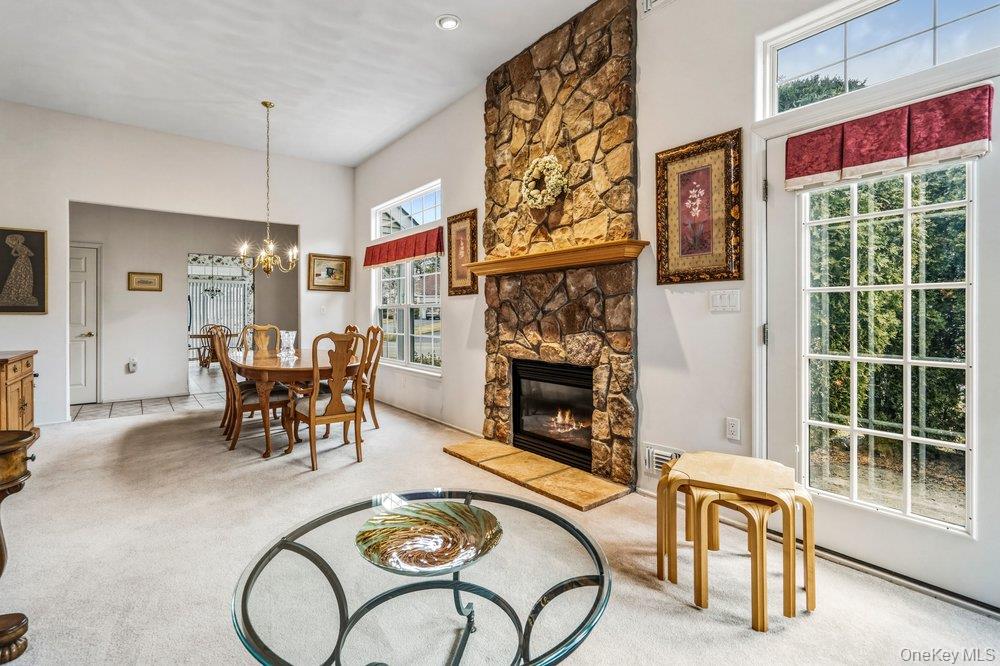 587 Leisure Drive Ridge, NY 11961 - Photo 12 of 49 a living room with furniture and a fireplace