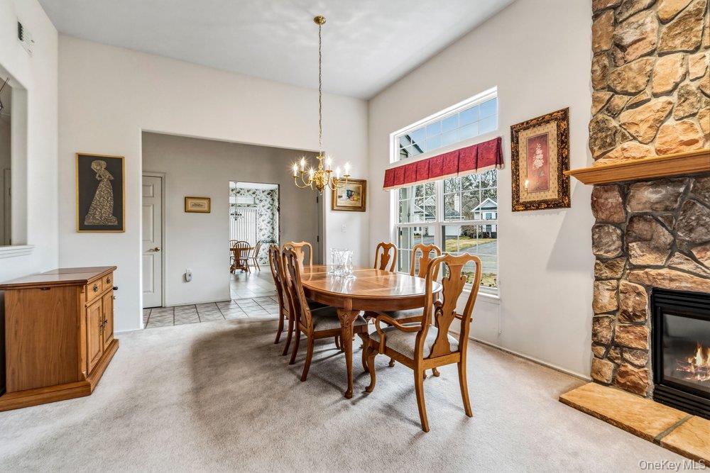 587 Leisure Drive Ridge, NY 11961 - Photo 13 of 49 a view of a dining room with furniture window and wooden floor