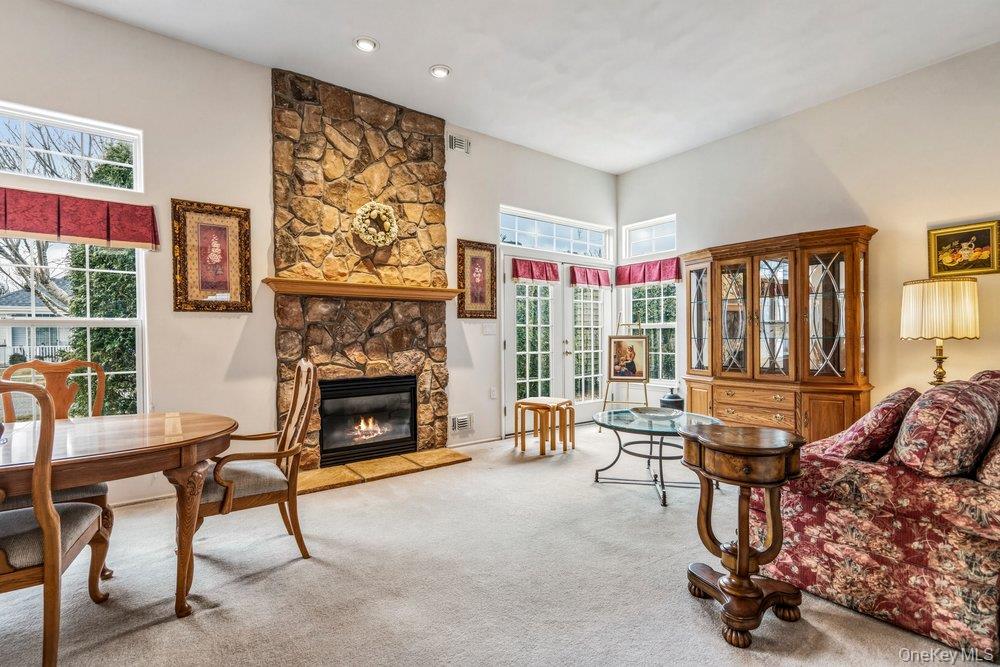 587 Leisure Drive Ridge, NY 11961 - Photo 15 of 49 a living room with furniture and a fireplace