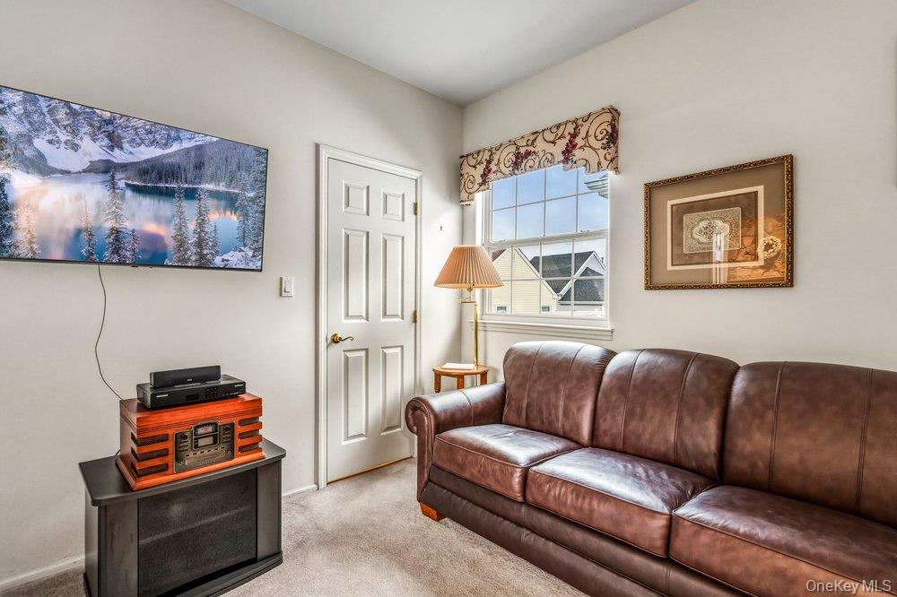 587 Leisure Drive Ridge, NY 11961 - Photo 17 of 49 a living room with furniture and a piano