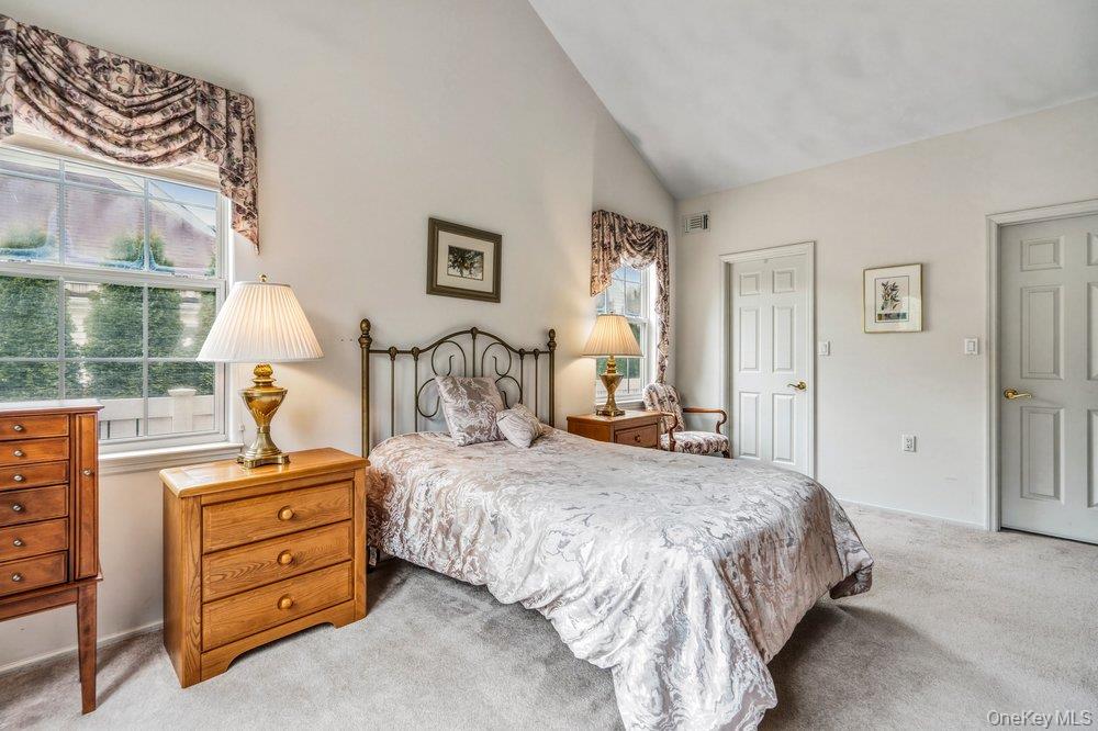 587 Leisure Drive Ridge, NY 11961 - Photo 19 of 49 a bedroom with a bed and wooden floor