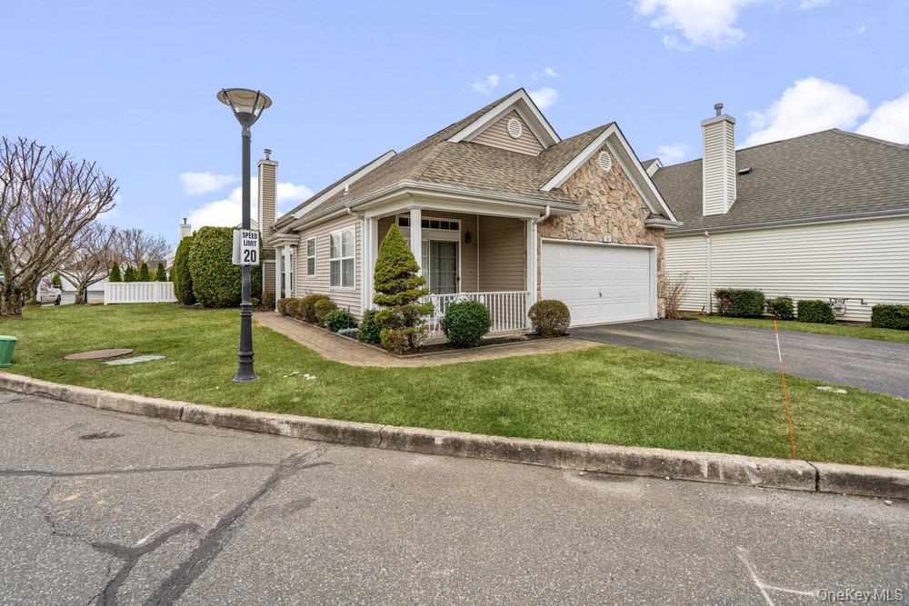 587 Leisure Drive Ridge, NY 11961 - Photo 2 of 49 a front view of a house with a yard
