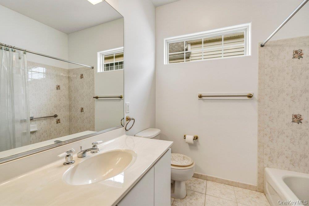 587 Leisure Drive Ridge, NY 11961 - Photo 23 of 49 a bathroom with a sink toilet and shower