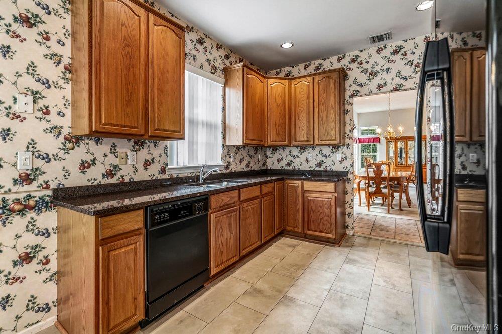 587 Leisure Drive Ridge, NY 11961 - Photo 27 of 49 a kitchen with stainless steel appliances granite countertop a stove a sink and a refrigerator