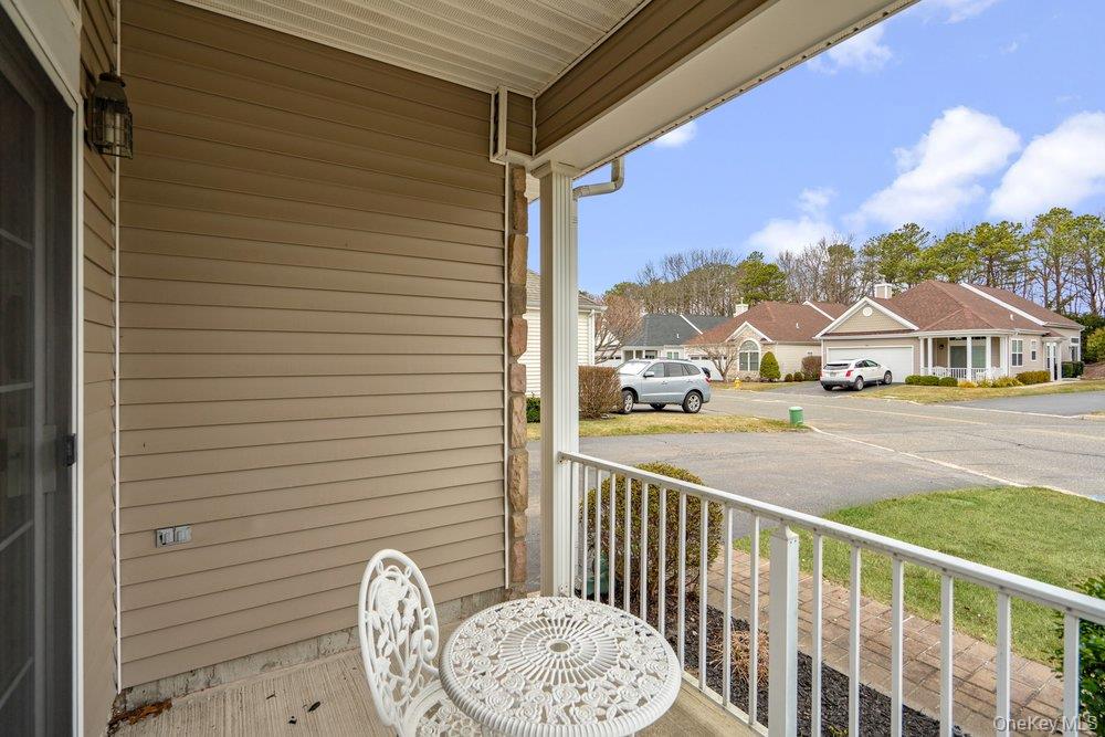 587 Leisure Drive Ridge, NY 11961 - Photo 35 of 49 a view of a porch with wooden floor