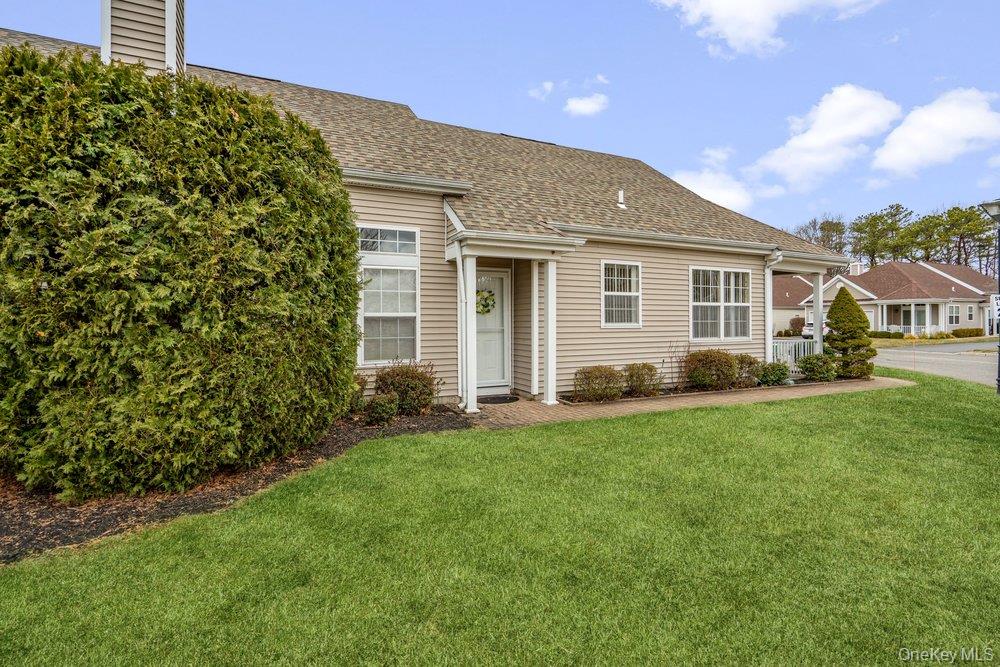 587 Leisure Drive Ridge, NY 11961 - Photo 4 of 49 a front view of house with yard and green space