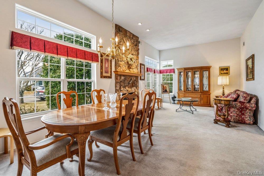 587 Leisure Drive Ridge, NY 11961 - Photo 7 of 49 a view of a dining room with furniture window and outside view