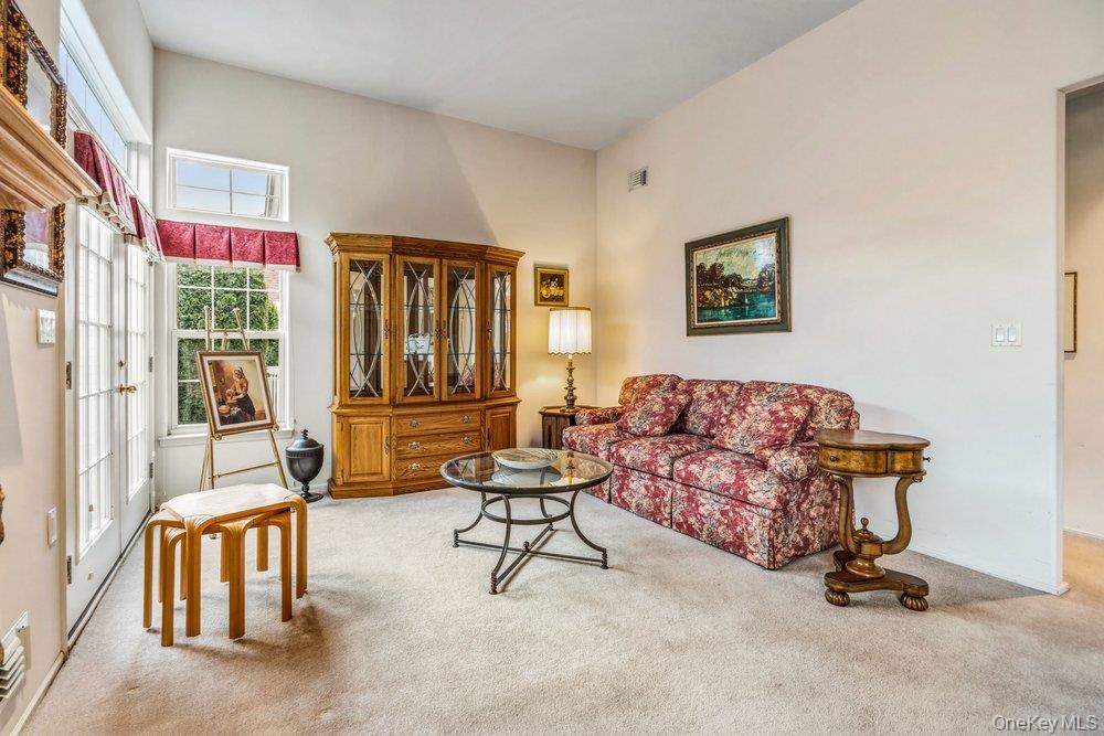 587 Leisure Drive Ridge, NY 11961 - Photo 10 of 49 a living room with furniture and a floor to ceiling window