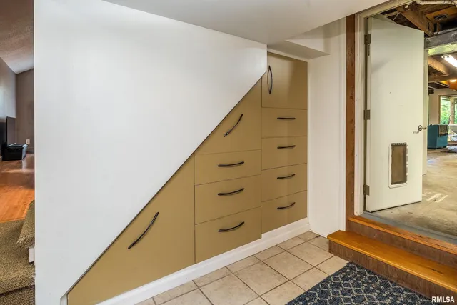 a bedroom with a bed chair and the window