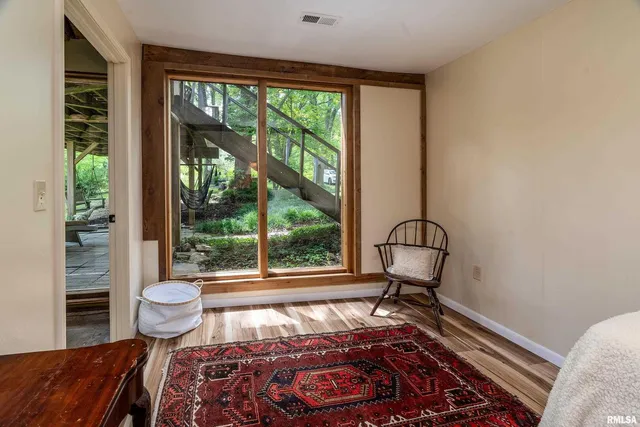 a backyard of a house with plants and large trees