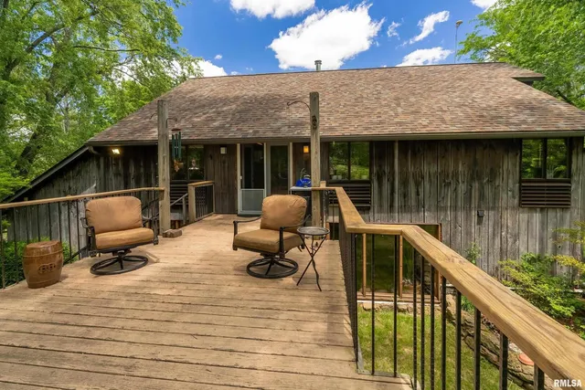 a view of a chairs and fire pit in a balcony