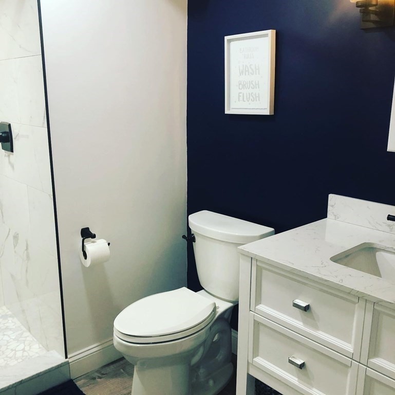 1 Park Road, Unit 1 Sandwich, MA 02644 - Photo 20 of 25 a white toilet sitting next to a bathroom sink
