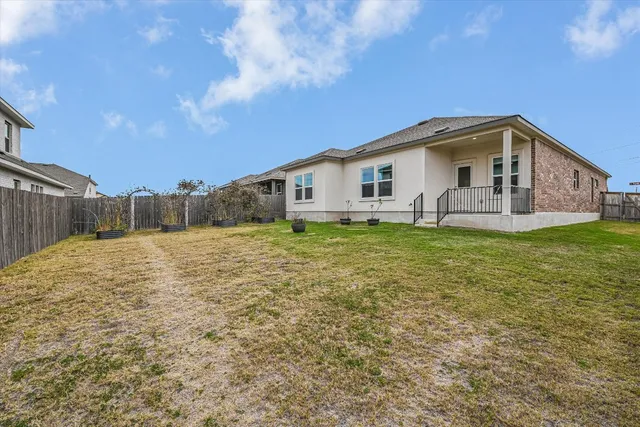 a view of a house with a backyard
