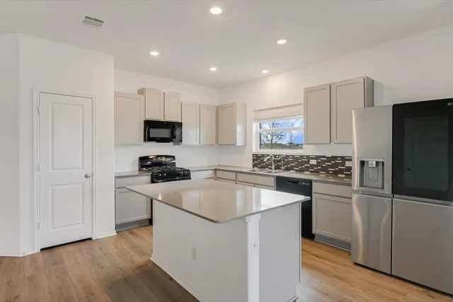 a kitchen with a sink stove and refrigerator