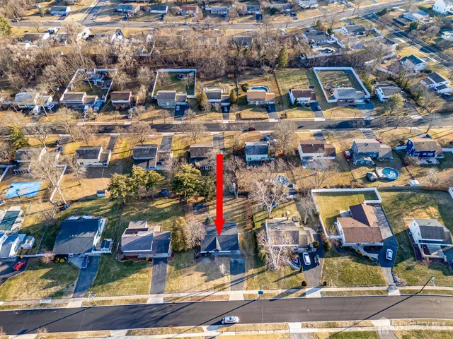 a large white kitchen with stainless steel appliances granite countertop a refrigerator oven a sink dishwasher and white cabinets with wooden floor