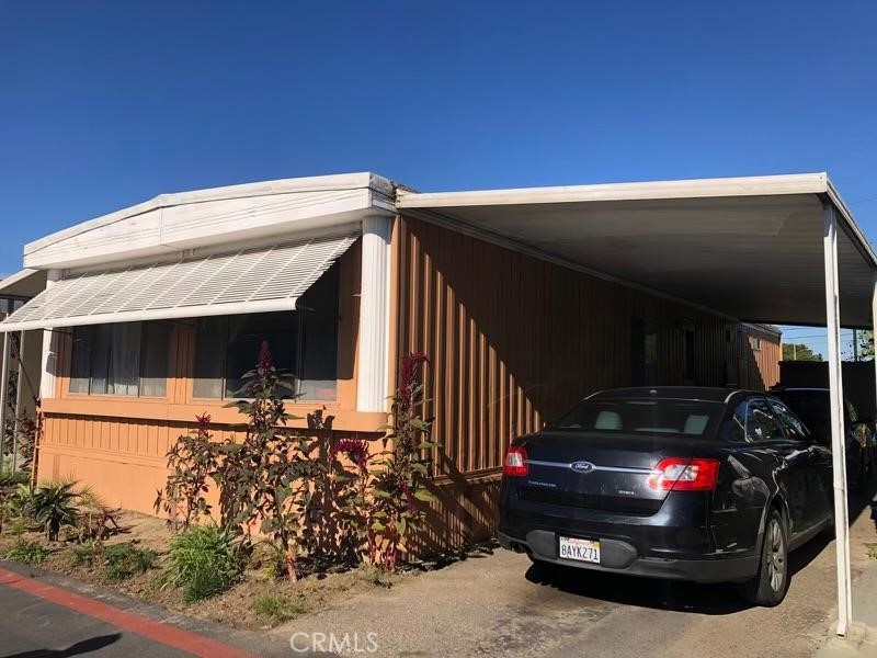 3050 West Ball Road, Unit 195 Anaheim, CA 92804 - Photo 2 of 19 a view of parked car in front of house