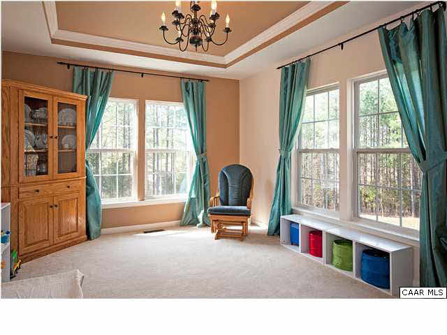 1099 Willow Ridge Road Troy, VA 22974 - Photo 6 of 39 a living room with large windows and a chandelier