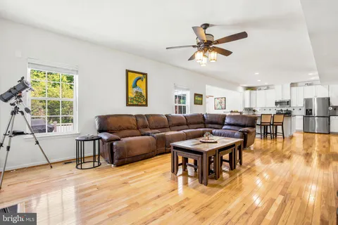 a living room with furniture a wooden floor and a window
