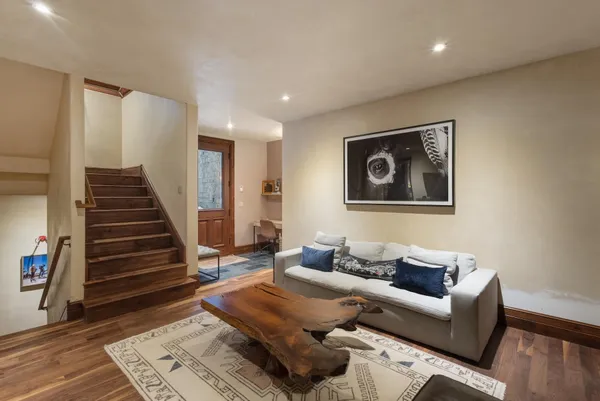 a living room with furniture and wooden floor