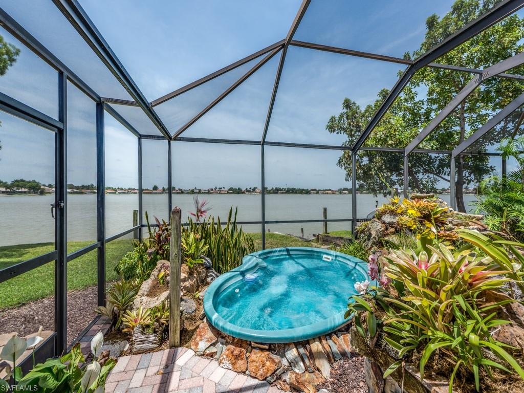 7175 Mill Pond Circle Naples, FL 34109 - Photo 11 of 14 a view of a swimming pool with a backyard