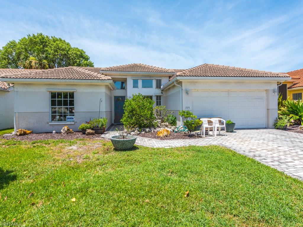 7175 Mill Pond Circle Naples, FL 34109 - Photo 13 of 14 a view of a house with backyard and sitting area
