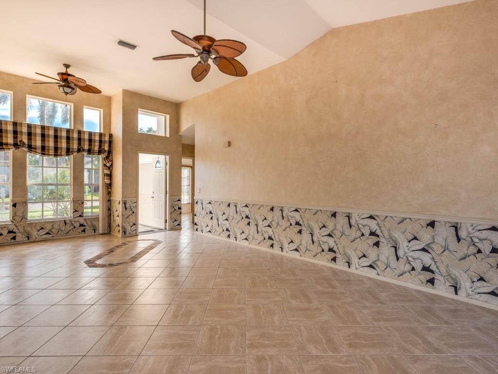 7175 Mill Pond Circle Naples, FL 34109 - Photo 4 of 14 a view of a livingroom with wooden floor and windows