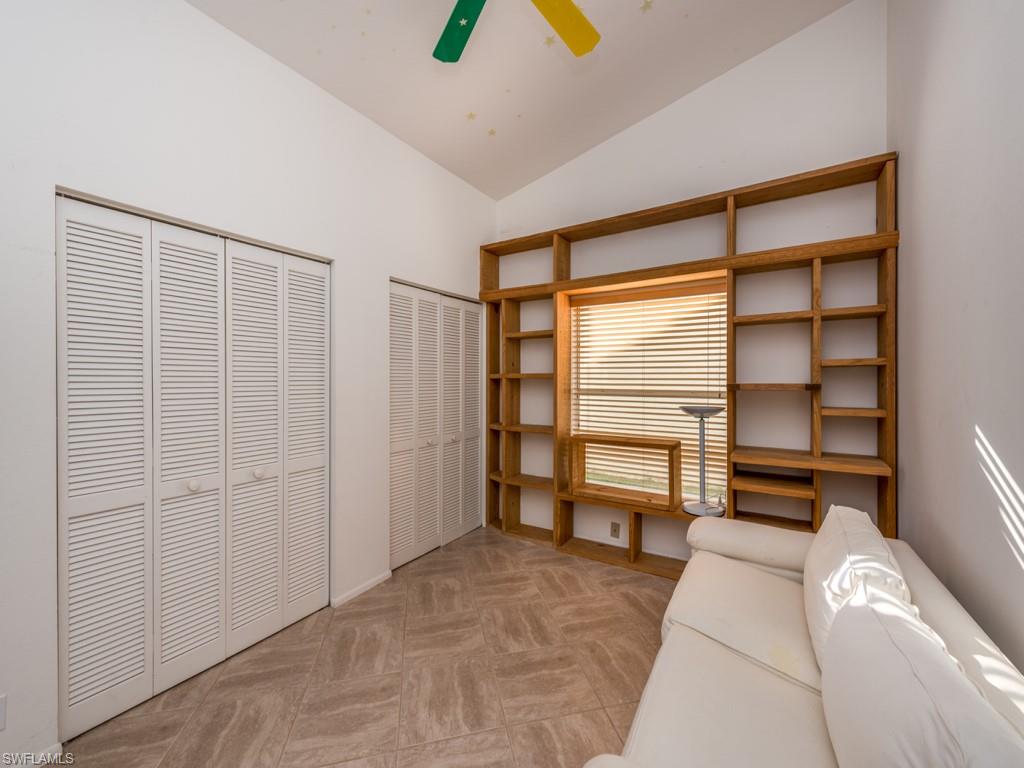 7175 Mill Pond Circle Naples, FL 34109 - Photo 7 of 14 a room with a bed and a flat tv screen