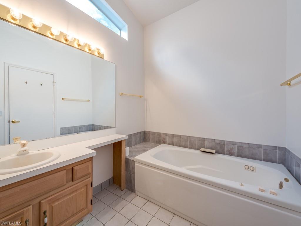7175 Mill Pond Circle Naples, FL 34109 - Photo 8 of 14 a bathroom with a bathtub and a sink