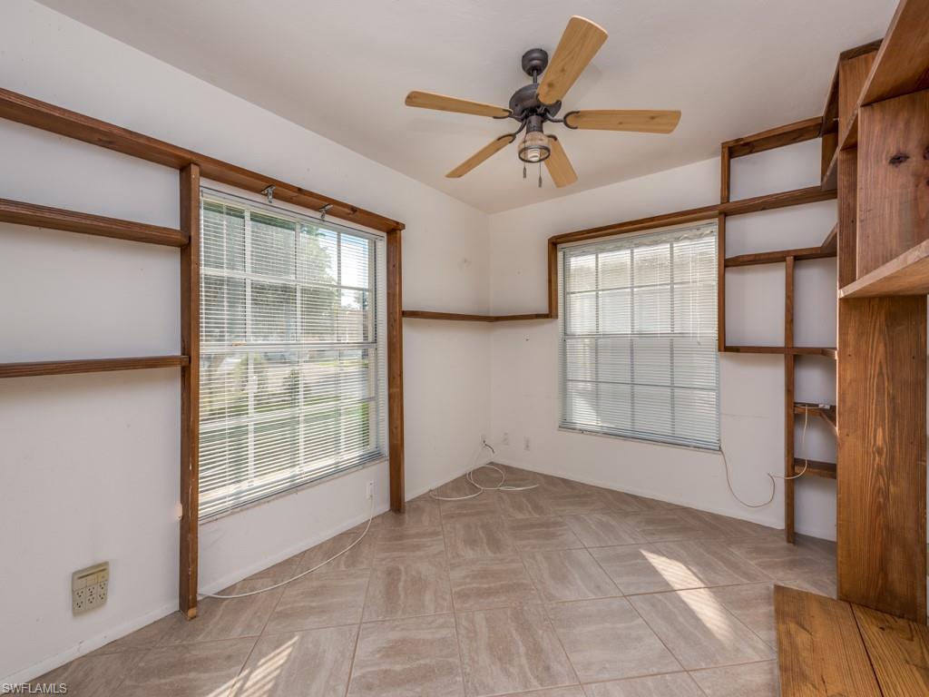 7175 Mill Pond Circle Naples, FL 34109 - Photo 9 of 14 a view of an empty room with a window