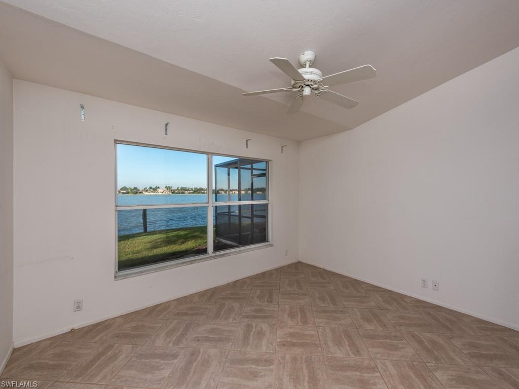 7175 Mill Pond Circle Naples, FL 34109 - Photo 10 of 14 a view of an empty room with a window