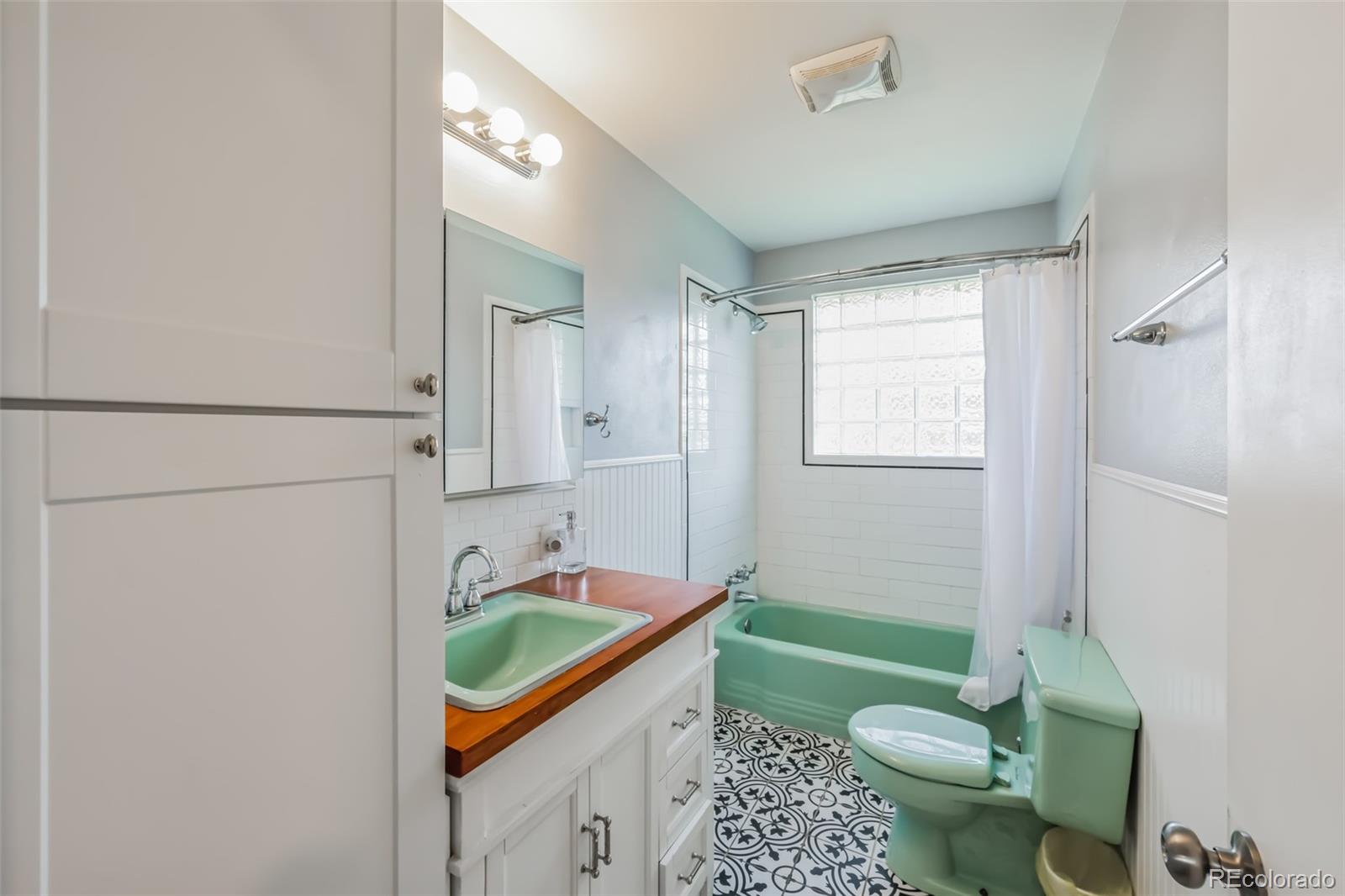 1070 South Decatur Street Denver, CO 80219 - Photo 14 of 18 a spacious bathroom with a granite countertop sink mirror vanity and toilet