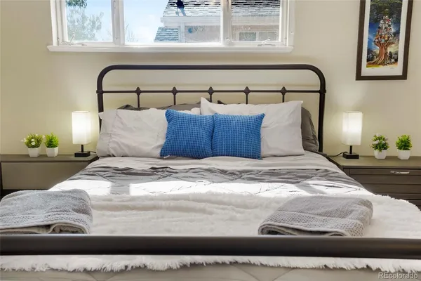 a large bed sitting in a bedroom next to a window