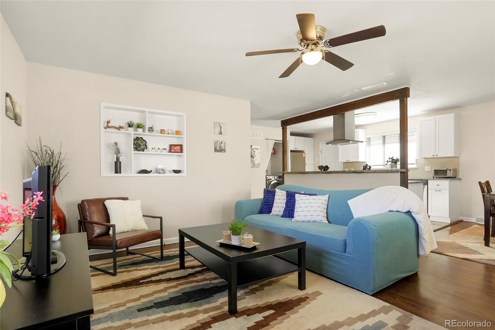 1070 South Decatur Street Denver, CO 80219 - Photo 2 of 18 a living room with furniture and a large window