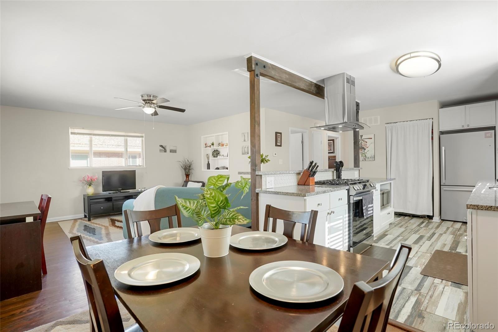1070 South Decatur Street Denver, CO 80219 - Photo 3 of 18 a view of a dining room with furniture and wooden floor