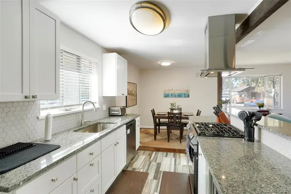 a large kitchen with lots of counter space a sink and appliances