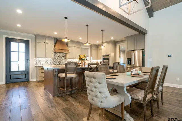 a large white kitchen with a large window
