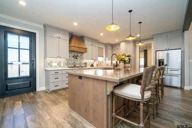a large kitchen with a table and chairs