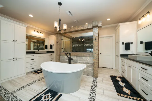 a bathroom with a granite countertop toilet a sink and a shower