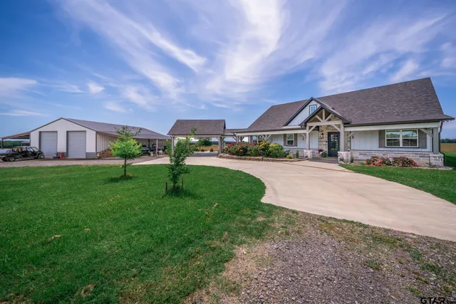 a front view of house with yard and green space