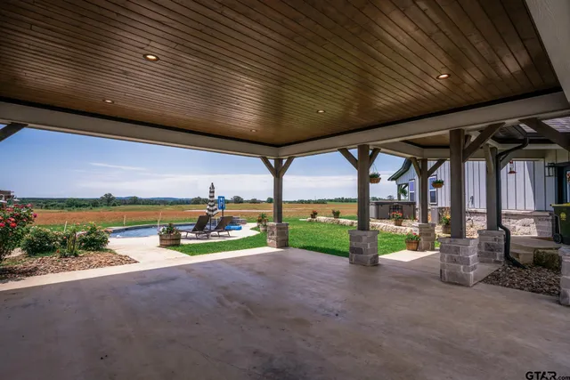 a backyard of a house with garden and plants
