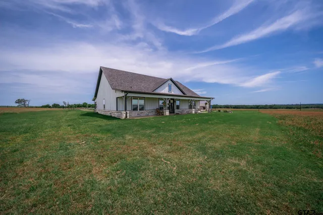 an aerial view of a golf course with a field