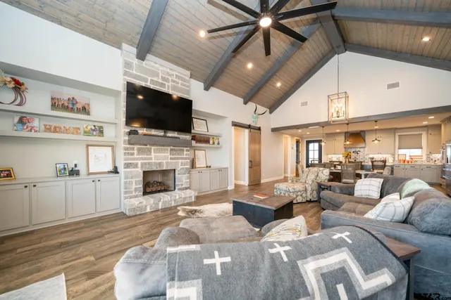 a living room with furniture a fireplace and a flat screen tv
