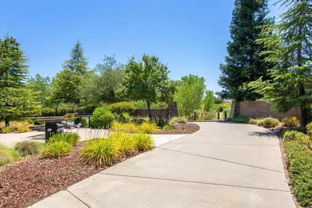 a view of swimming pool with a table and chairs under an umbrella
