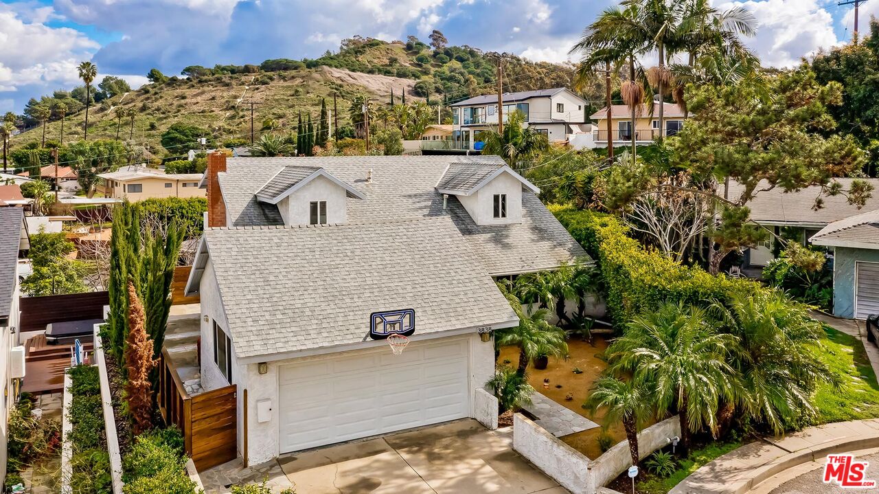 aerial view of a house with a yard and potted plants