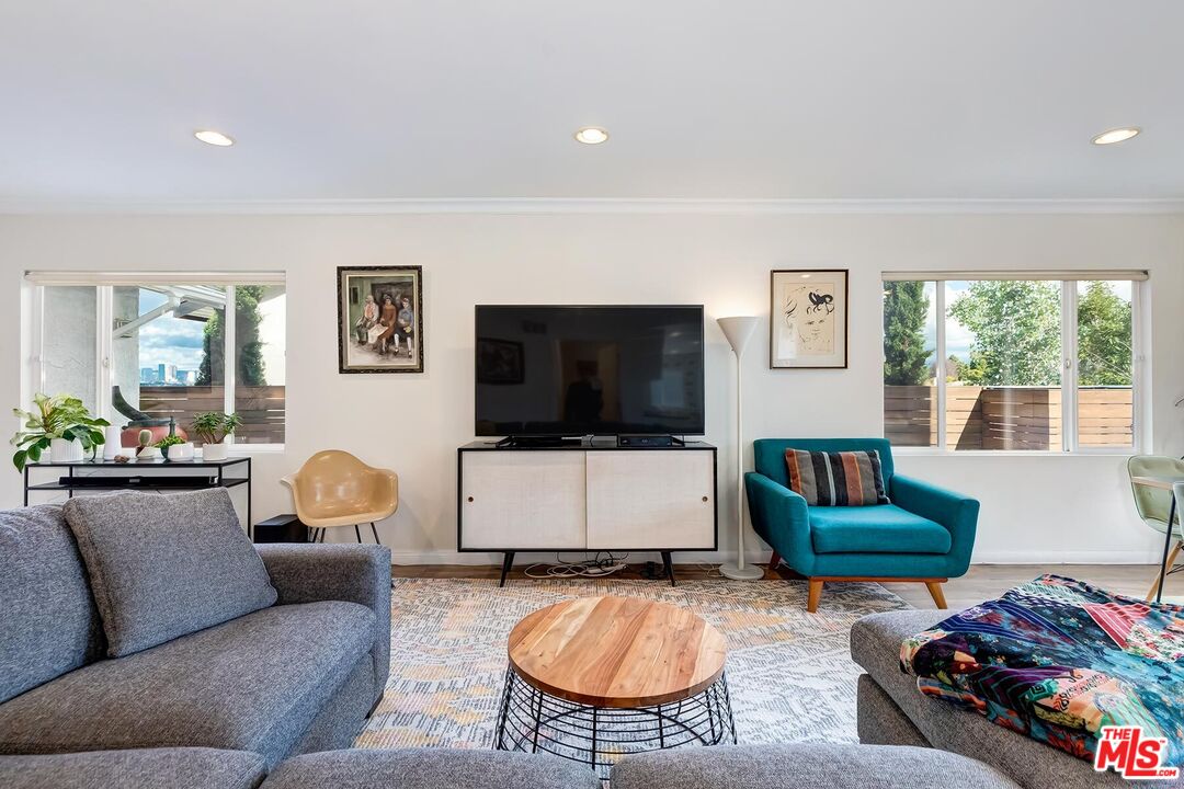 3838 Crestview Road Culver City, CA 90232 - Photo 11 of 53 a living room with furniture and a flat screen tv