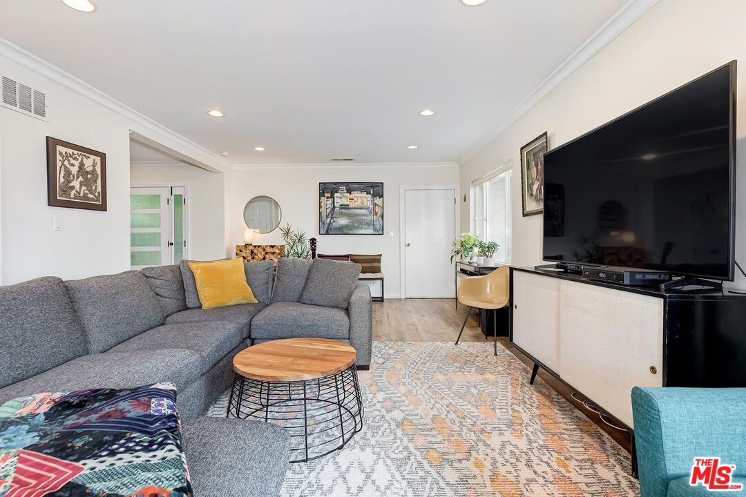 3838 Crestview Road Culver City, CA 90232 - Photo 12 of 53 a living room with furniture and a flat screen tv