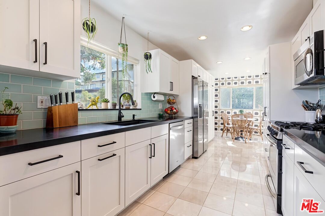 3838 Crestview Road Culver City, CA 90232 - Photo 15 of 53 a kitchen with sink a stove and cabinets