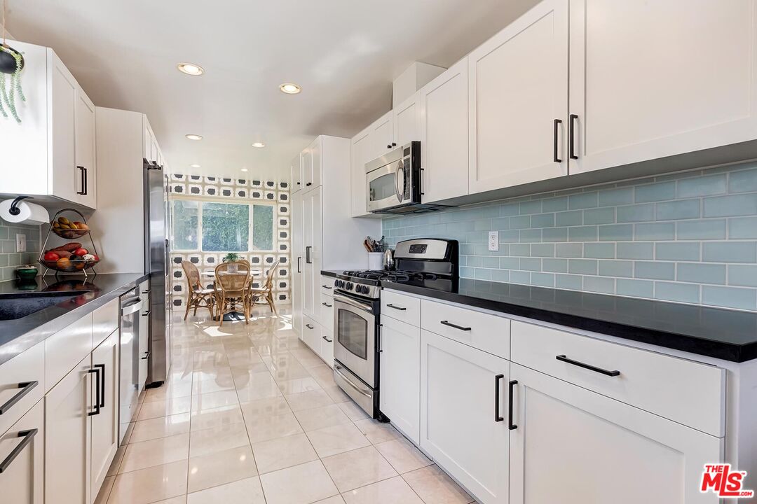 3838 Crestview Road Culver City, CA 90232 - Photo 17 of 53 a kitchen with stainless steel appliances granite countertop a sink and cabinets